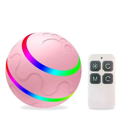 Pink interactive cat ball toy by NexiPets with a rainbow light stripe, paw print texture, and a white remote control.